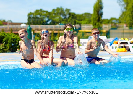 happy friends eat ice cream and enjoy summer in pool