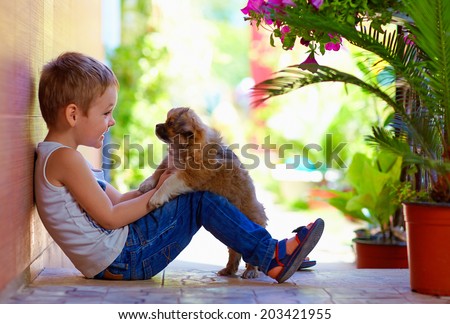 excited boy playing with beloved puppy