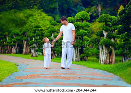 father sharing knowledge with son, while walking in garden
