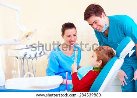 little kid, patient checking the result of medical procedure in dental clinic