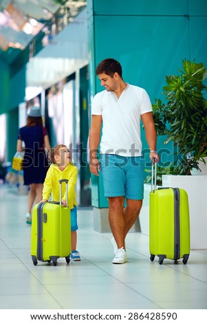 happy father and son are ready for boarding in international airport