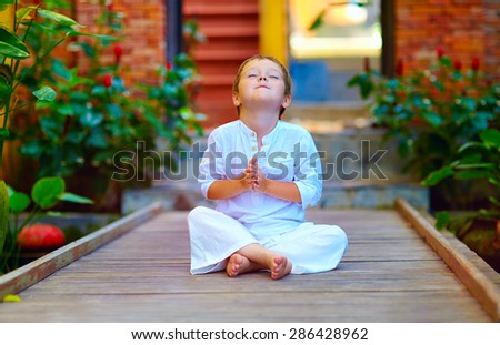cute boy trying to find inner balance in meditation