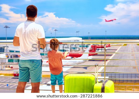 father and son ready for summer vacation, while waiting for boarding in international airport