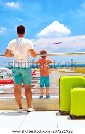 family watching the plane takes off, while waiting for boarding in international airport