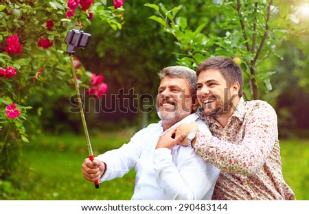 like father like son. family makes selfie on smartphone