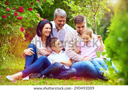 big happy family together in summer garden