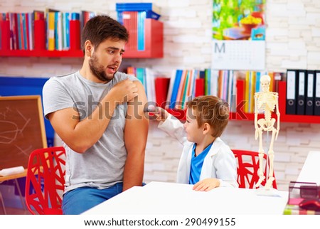 family playing in doctor and patient, father scared of injection