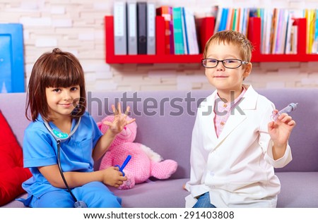 cute kids playing in doctors with toy instruments