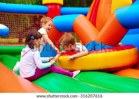 excited kids having fun on inflatable attraction playground