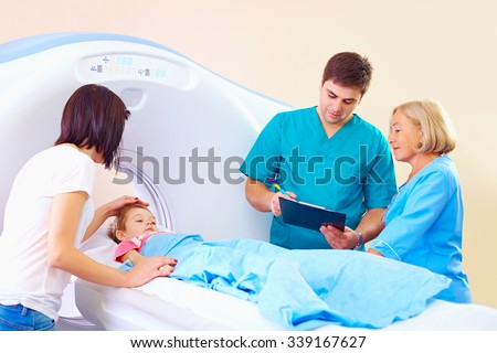 young mother soothing baby  before medical procedure in ct scanner