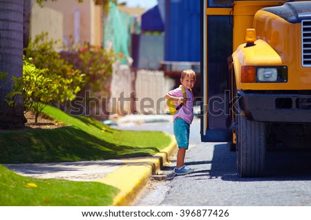 cute kid are getting on the bus, ready to go to school