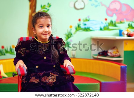 cute little girl in wheelchair at rehabilitation center for kids with special needs