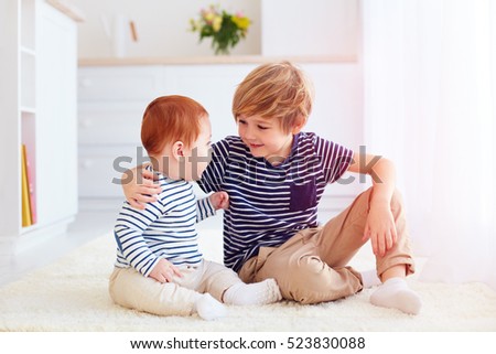 cute brothers playing together at home