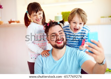 making selfie snap shot with crazy hairstyle and makeup when you home alone with children