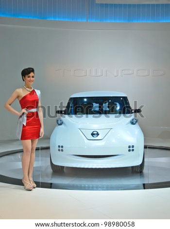 BANGKOK - MARCH 30: Nissan Zero emission car with unidentified model on display at The 33th Bangkok International Motor Show on March 30, 2012 in Bangkok, Thailand.