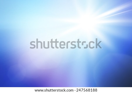 Shining sun at clear blue sky and lens flare with copy space