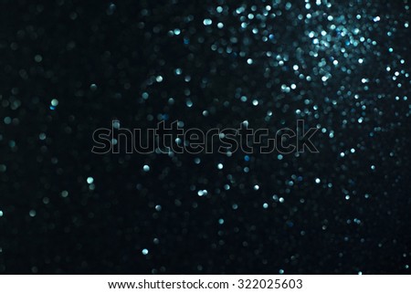 glitter vintage lights background. light blue, gold and black. defocused.