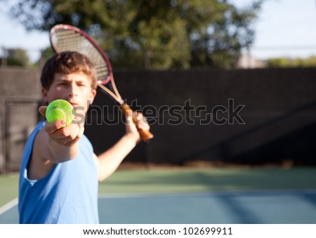 Teenager playing Tennis with determination