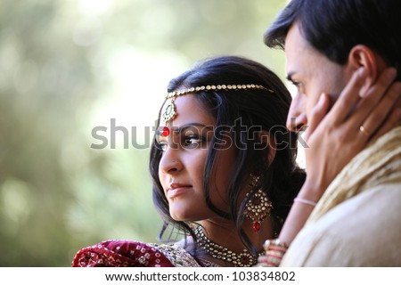 Gorgeous Indian bride and groom traditionally dressed