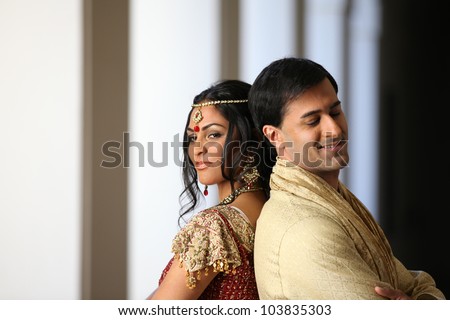 Gorgeous Indian bride and groom traditionally dressed