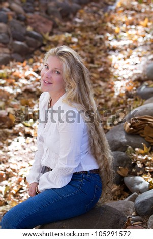Pretty Woman with Long Hair in fall leaves