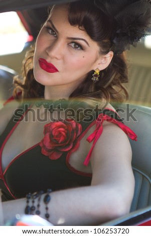 Beautiful Brunette woman driving a vintage car