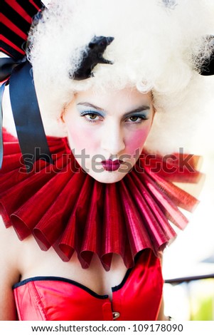 Beautiful Woman with heavy party makeup wearing a corset