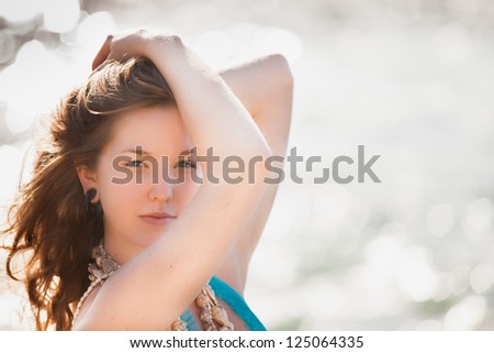 Beautiful young woman in shells as if a mermaid