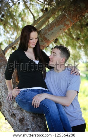 Man and woman under a tree hugging