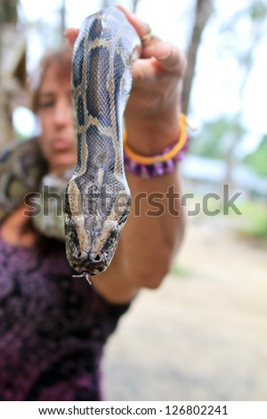 Pretty Woman Holding a snake with the snake in focus