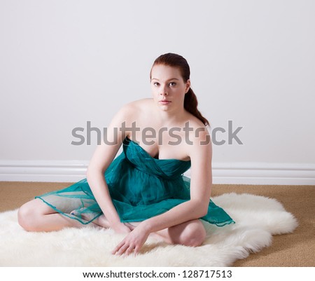 Pretty Dancer on a fur rug in a spring time dress
