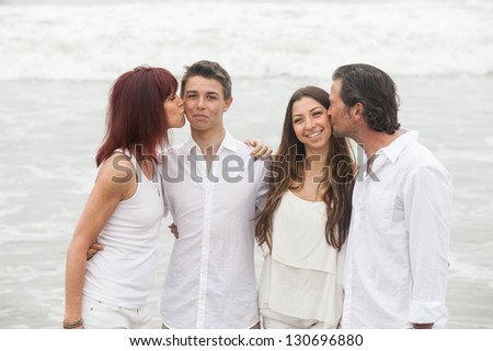 Good looking family kissing each other in show of affection