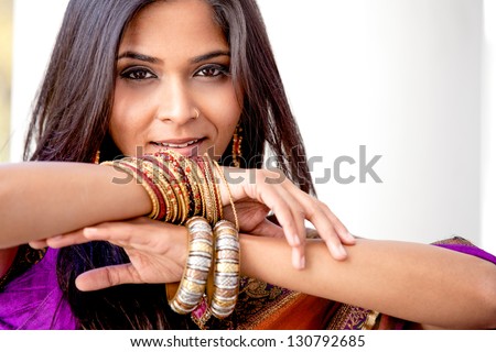 Beautiful Asian woman framed by her hands and jewelry