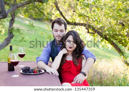 Beautiful Young Couple on a Picnic under trees