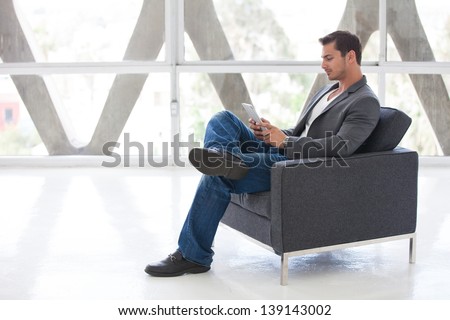 Attractive business man in his 20s working on a think pad