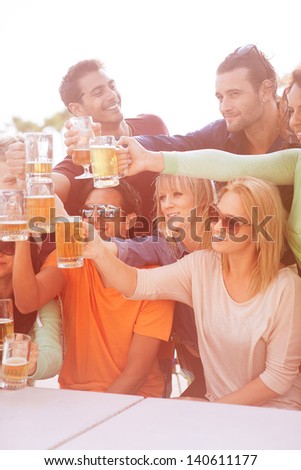 Group of Attractive young People toasting with a delicious Pale Ale  Beer