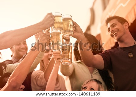 Group Of Attractive Young People Toasting With A Delicious Pale Ale Beer