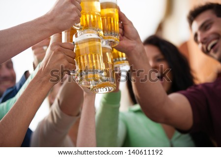 Group Of Attractive Young People Toasting With A Delicious Pale Ale Beer