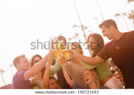 Young People in their twenties on the Venice Beach boardwalk in California drinking beer