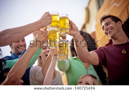 Young People in their twenties on the Venice Beach boardwalk in California drinking beer
