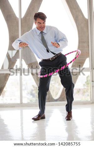 Business Man loosening up with a Hula Hoop for his meeting