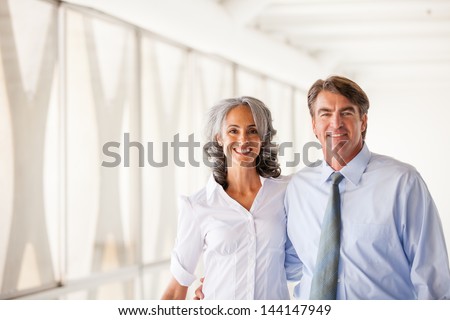 Good looking Business man and woman walking smiling at camera