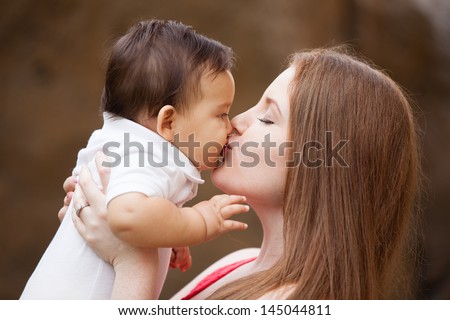 Pretty young Mom kissing her baby boy