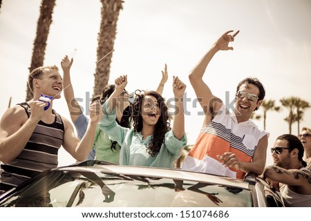 Young People In A Car Having Fun On A Road Trip