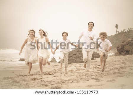 Happy Healthy Family Running at the beach in Malibu California
