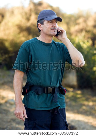 Handsome Middle Age Man Hiking Talking on his cell phone