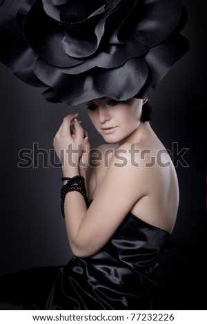 dark portrait of a girl in a dark roses suit