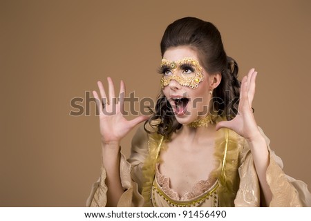 Studio shot of a mysterious party-girl with a mask-covered face