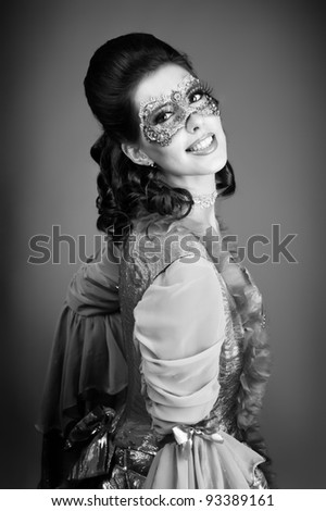 black and white portrait of elegant girl with a mask painted on her face