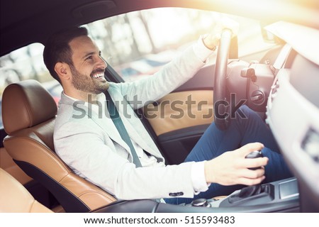 Businessman driving a car.